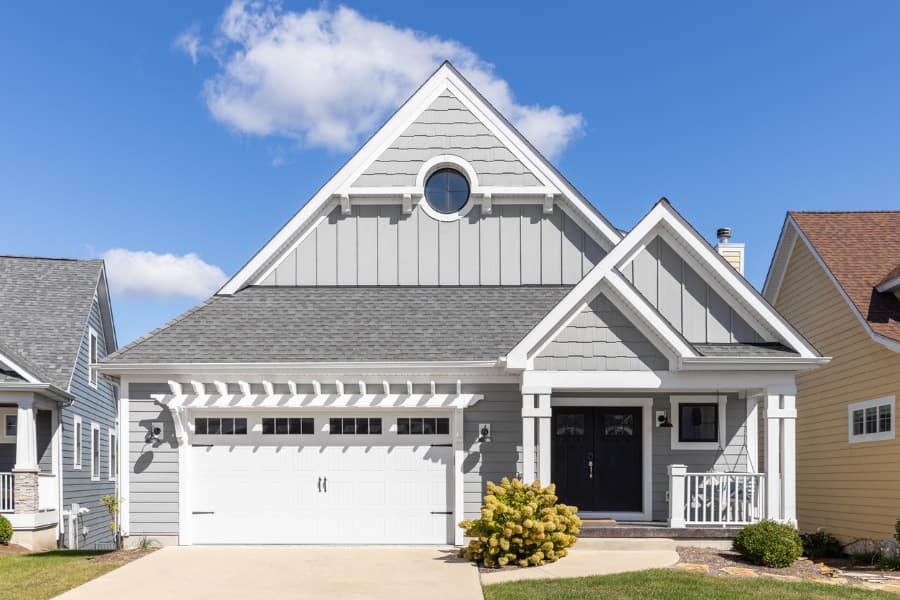 View of beautiful home from the curb with boar- and-batten-inspired vinyl siding