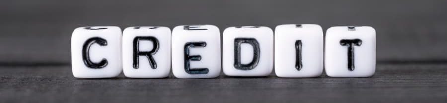 White cubes with letters spelling out the word credit
