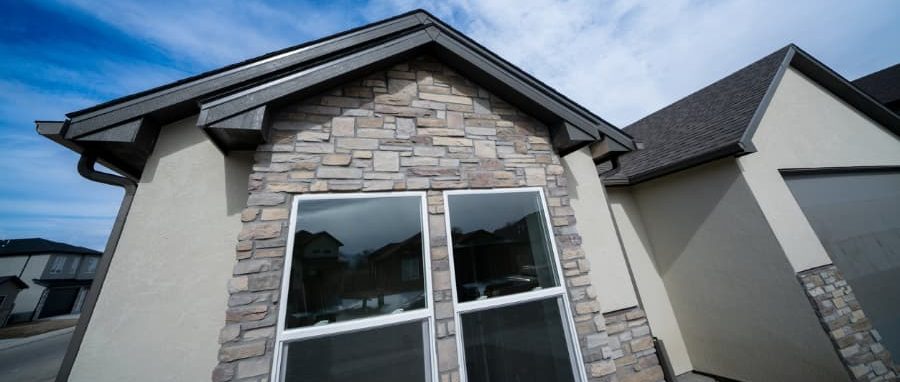Image of home with stucco siding and stone veneer