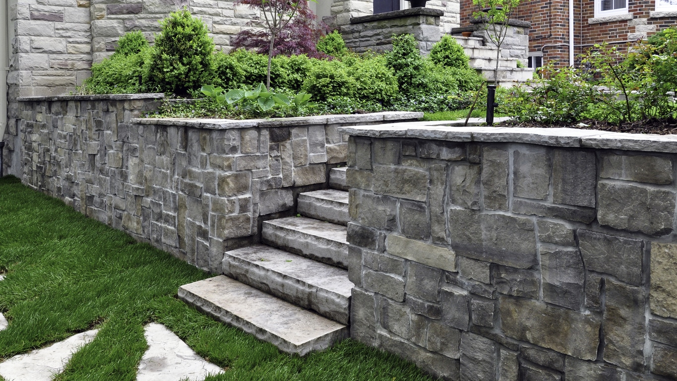 Luxury landscaping featuring retaining wall and stone steps