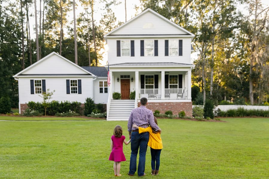 Family admiring look of replacement siding from curb